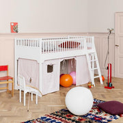 Oliver Furniture Seaside Classic bed curtain with a white-and-red stripe design creating a cozy play area beneath a white bunk bed, complete with a door, window, and pockets, suitable for Seaside Classic beds. 