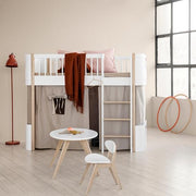 Oliver Furniture PingPong Kids Table in white and oak next to a children's bunk bed and floor lamp. 