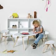 A child sits at an Oliver Furniture PingPong Kids Table in White & Oak, a versatile and stylish children's table made from Nordic oak, perfect for nurseries, kids' rooms, and playrooms. 