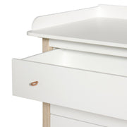 White and oak wood nursery dresser with four soft-close drawers and removable changing top by Oliver Furniture.