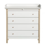 White and oak wood 4-drawer nursery dresser with removable changing table top, soft-close drawer rails, and copper handles by Oliver Furniture.
